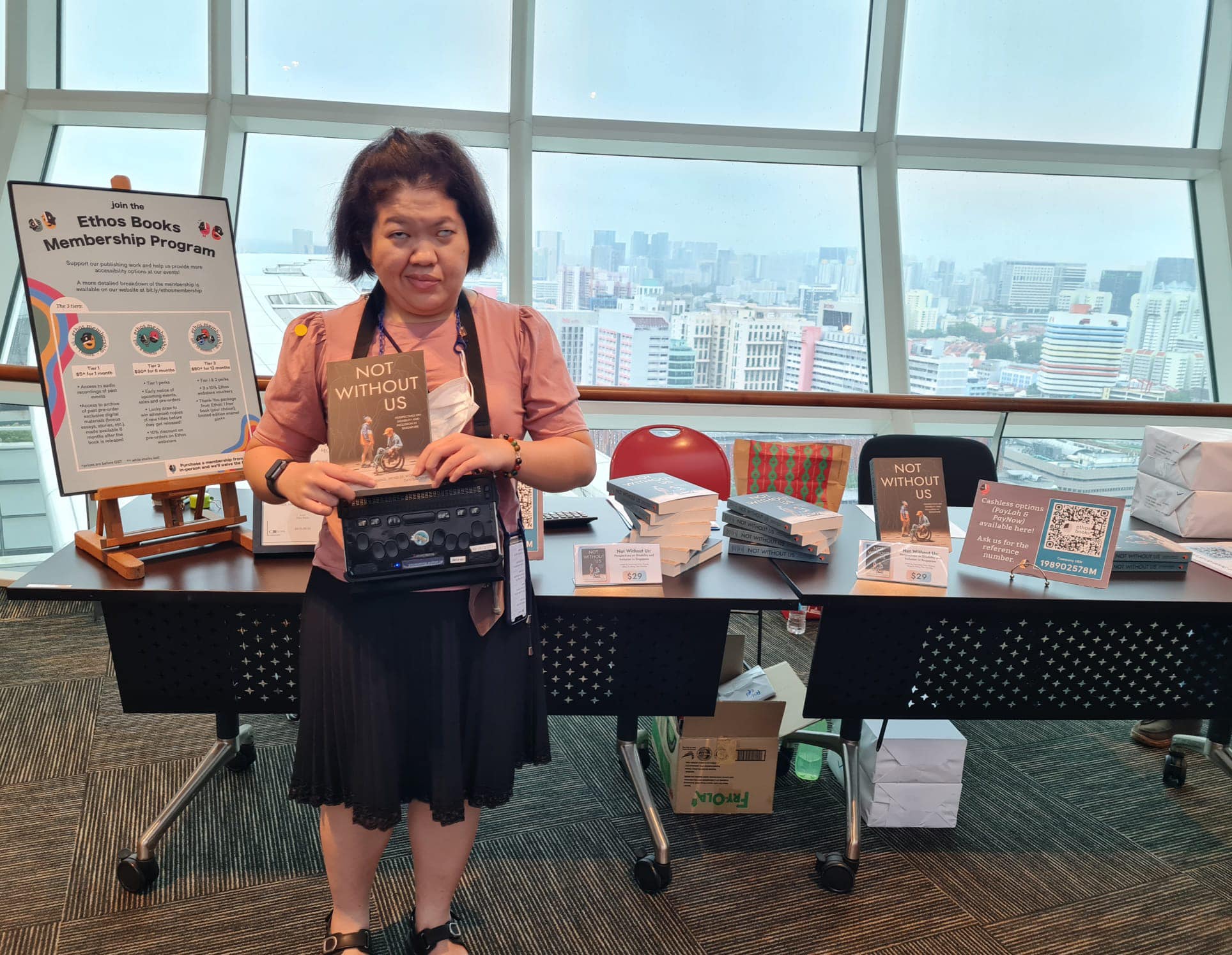 Siew Ling posing with a copy of Not Without Us during the book launch event.