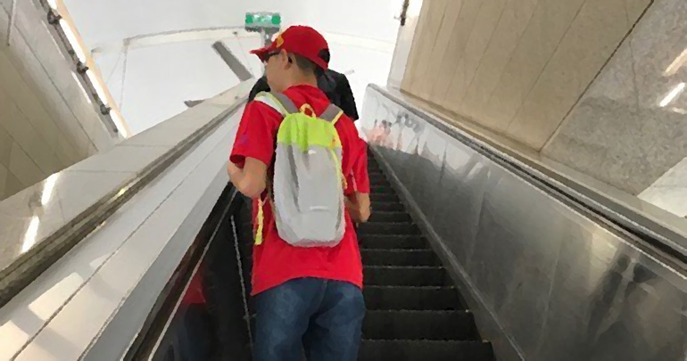 A child taking the escalator