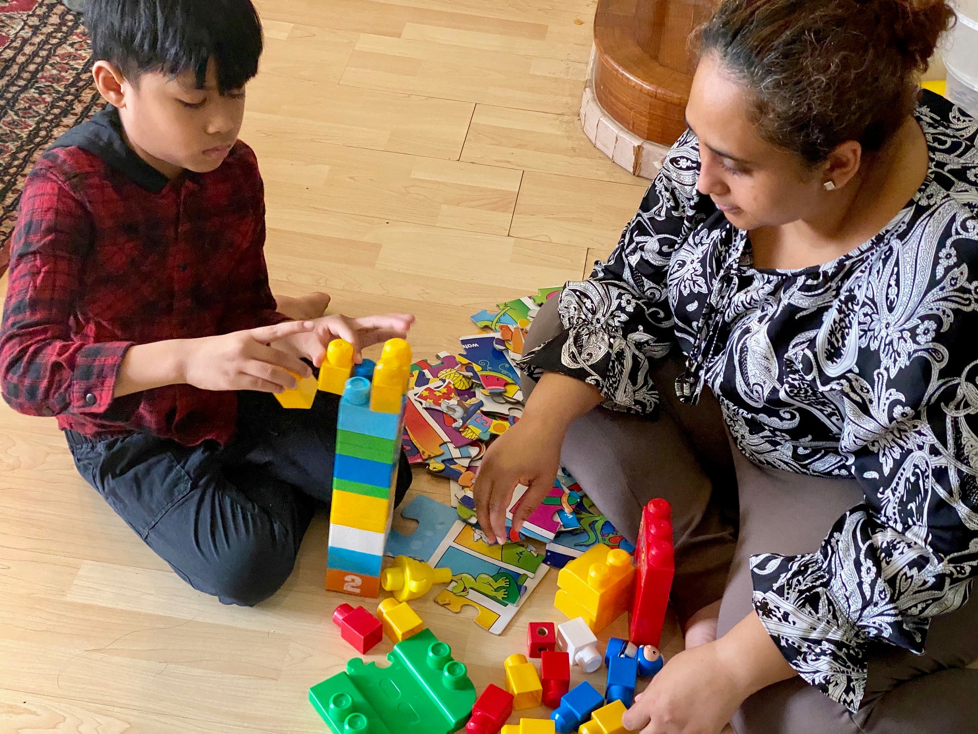 Farah playing with her son, Ilhan, using giant building blocks. Ilhan was diagnosed with ASD at age 4.
