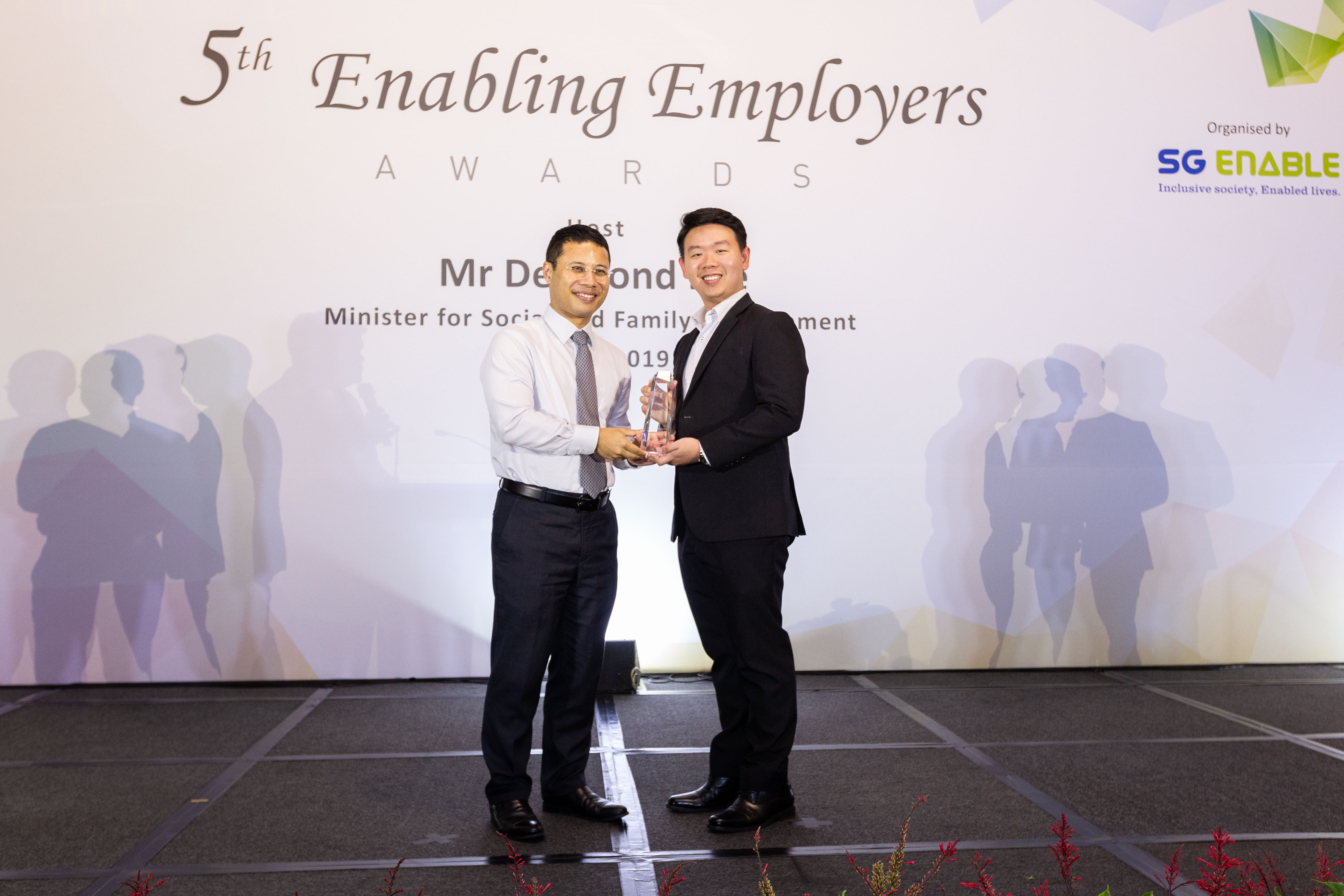 Benjamin (right) receiving the Enabling Champion Award at the 5th Enabling Employers Awards from Minister for Social and Family Development Desmond Lee.