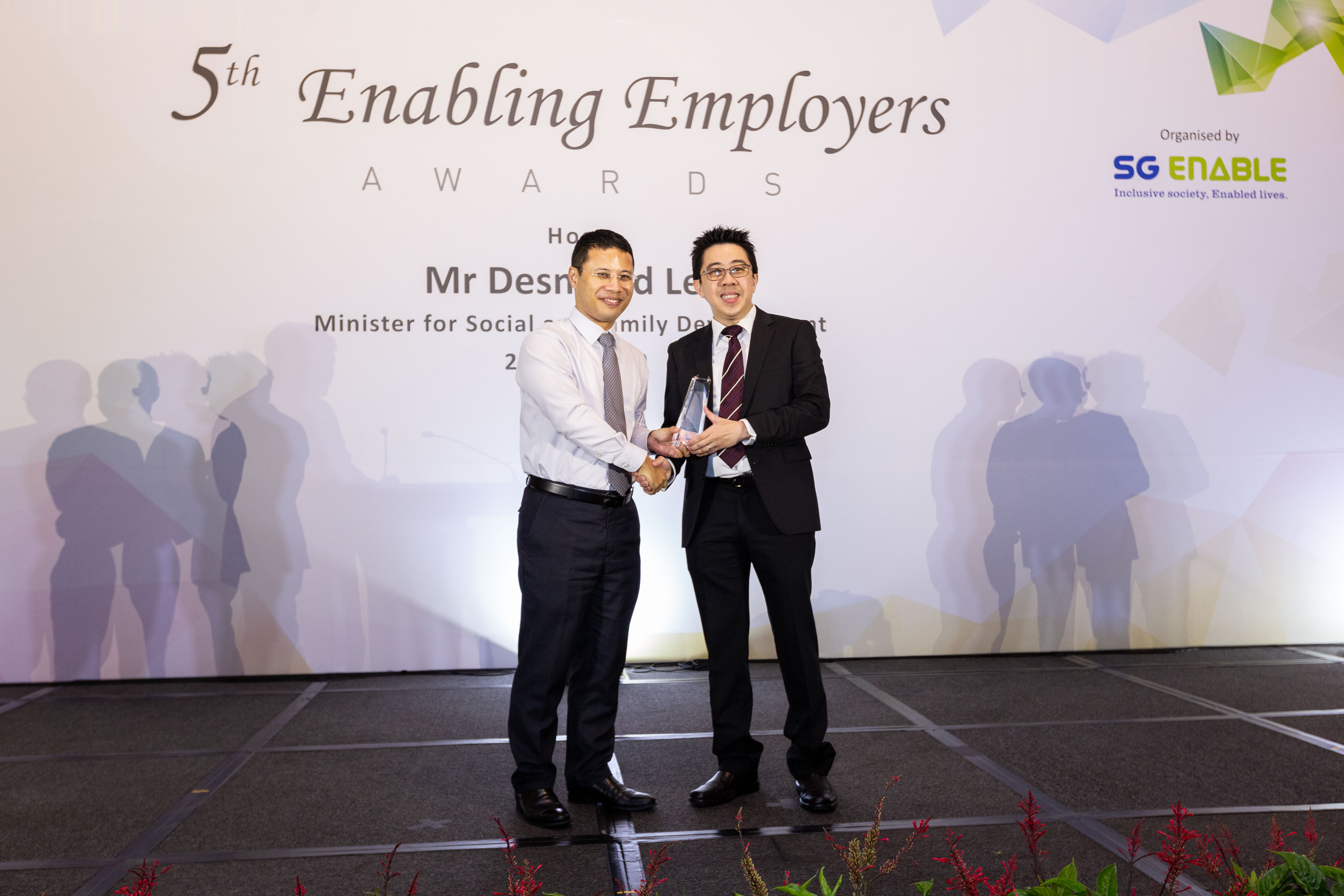 George (right) receiving the Enabling Champion Award at the 5th Enabling Employers Awards from Minister for Social and Family Development Desmond Lee.